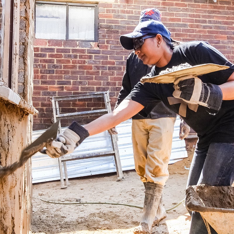 Two people working on a home construction project